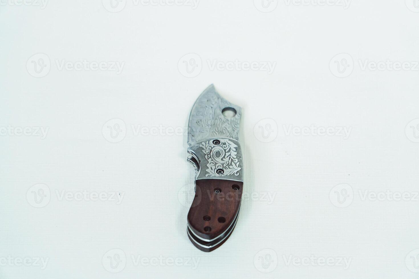 Close up of an adventure and bushcraft knife using a wooden handle. Knife with a sharp stainless steel blade with a wooden handle, perfect for outdoor adventures and bushcraft activities photo