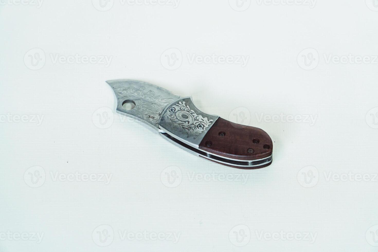 Close up of an adventure and bushcraft knife using a wooden handle. Knife with a sharp stainless steel blade with a wooden handle, perfect for outdoor adventures and bushcraft activities photo