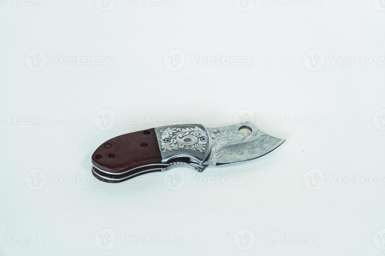 Close up of an adventure and bushcraft knife using a wooden handle. Knife with a sharp stainless steel blade with a wooden handle, perfect for outdoor adventures and bushcraft activities photo