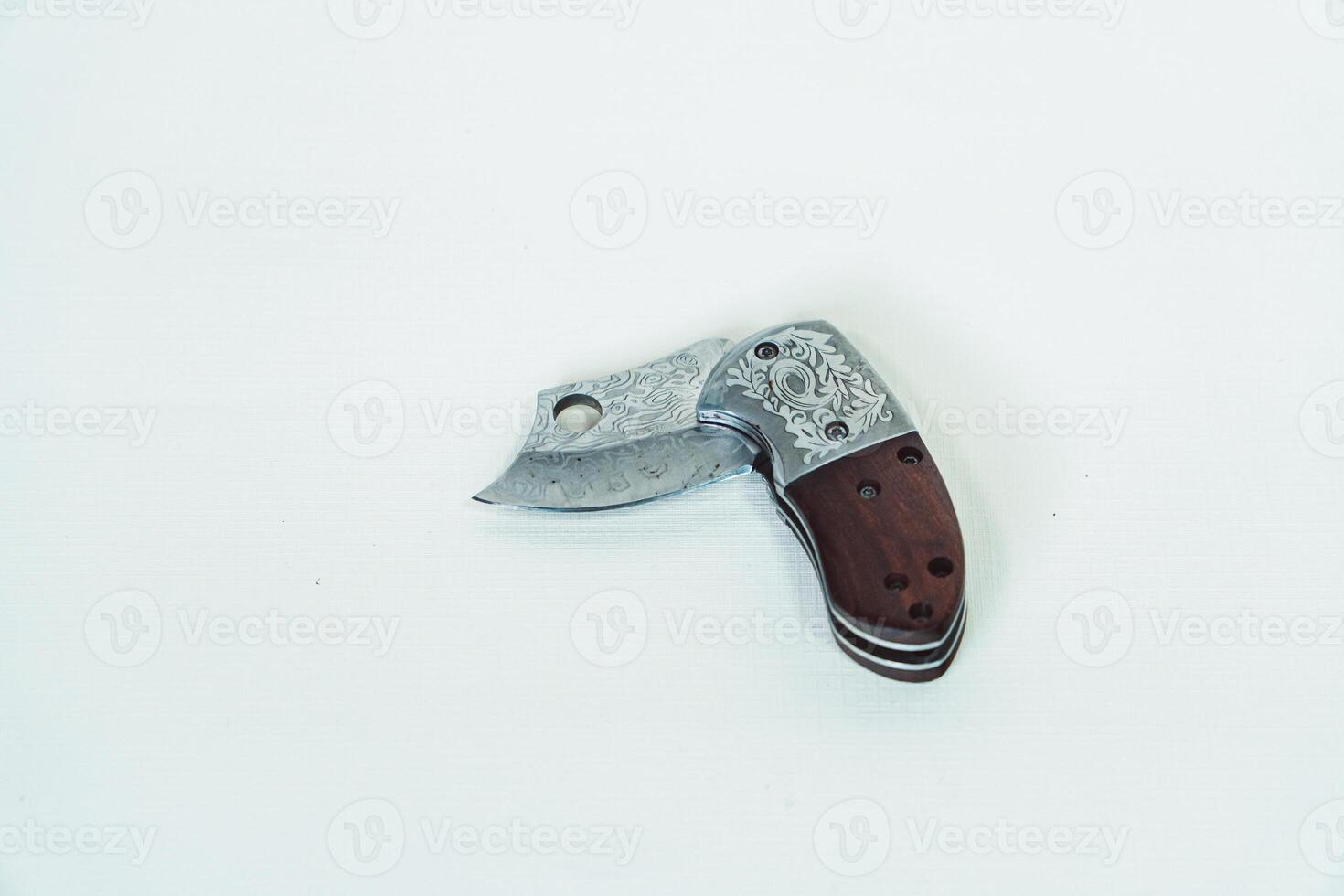 Close up of an adventure and bushcraft knife using a wooden handle. Knife with a sharp stainless steel blade with a wooden handle, perfect for outdoor adventures and bushcraft activities photo