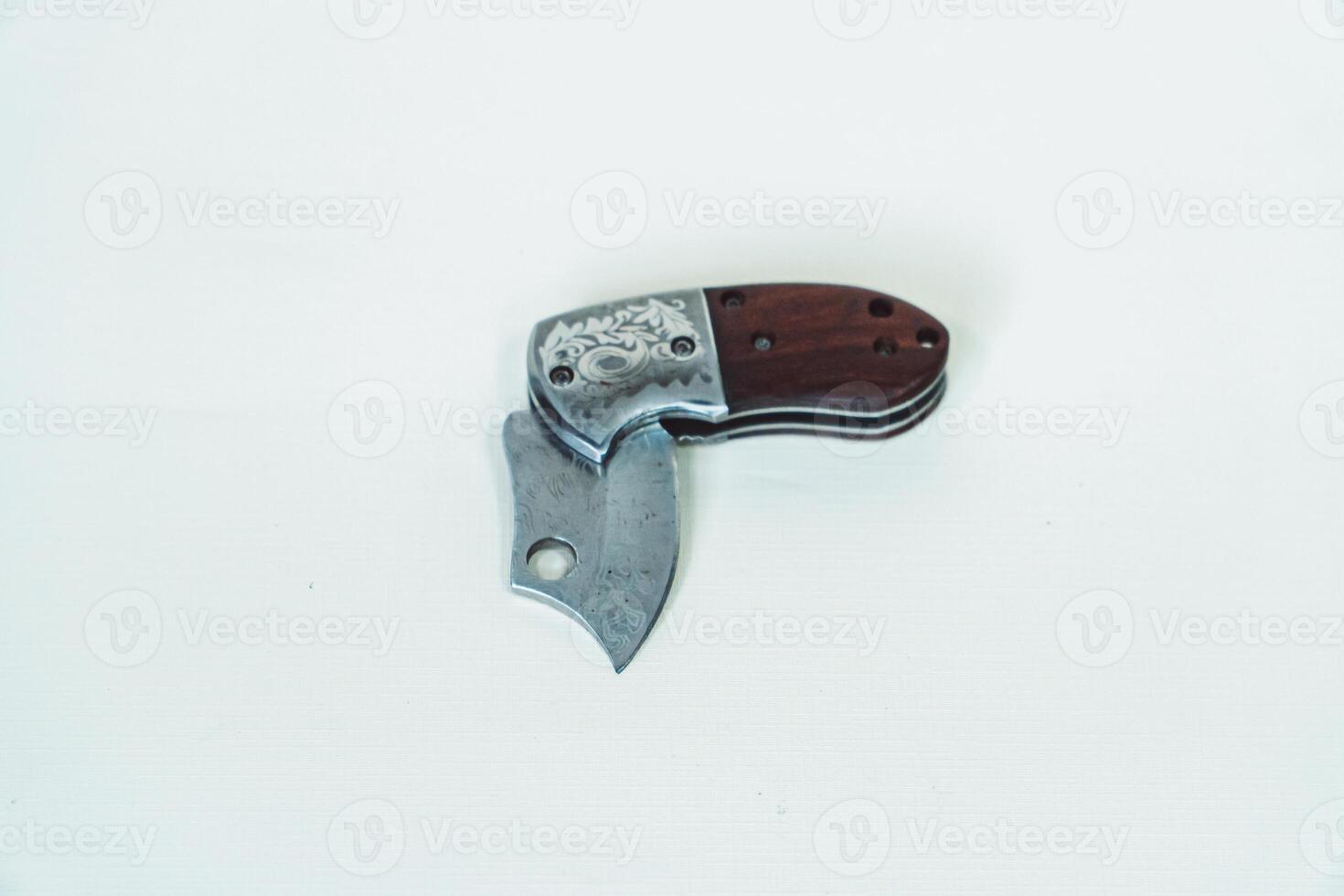 Close up of an adventure and bushcraft knife using a wooden handle. Knife with a sharp stainless steel blade with a wooden handle, perfect for outdoor adventures and bushcraft activities photo