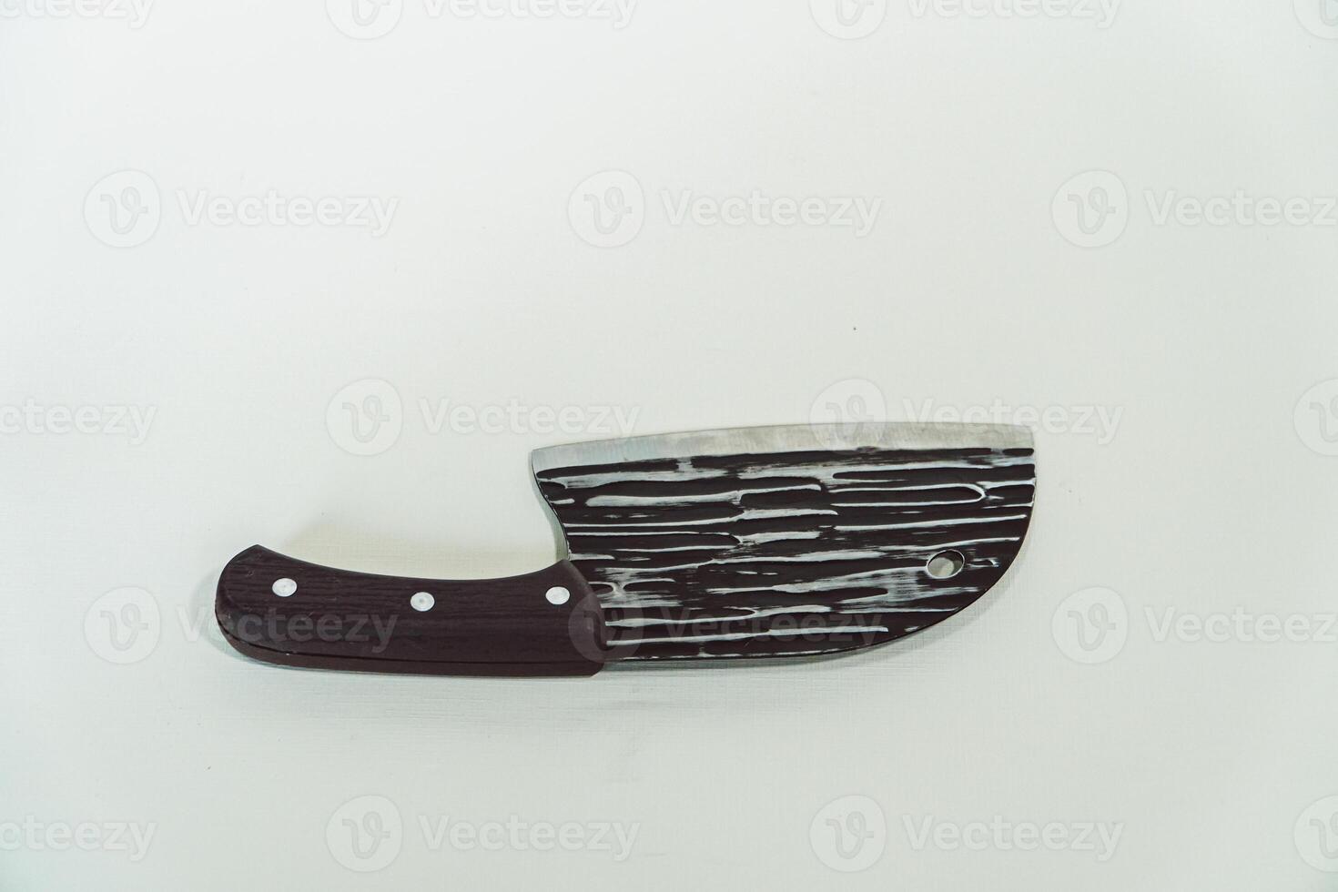 Close up of an adventure and bushcraft knife using a wooden handle. Knife with a sharp stainless steel blade with a wooden handle, perfect for outdoor adventures and bushcraft activities photo