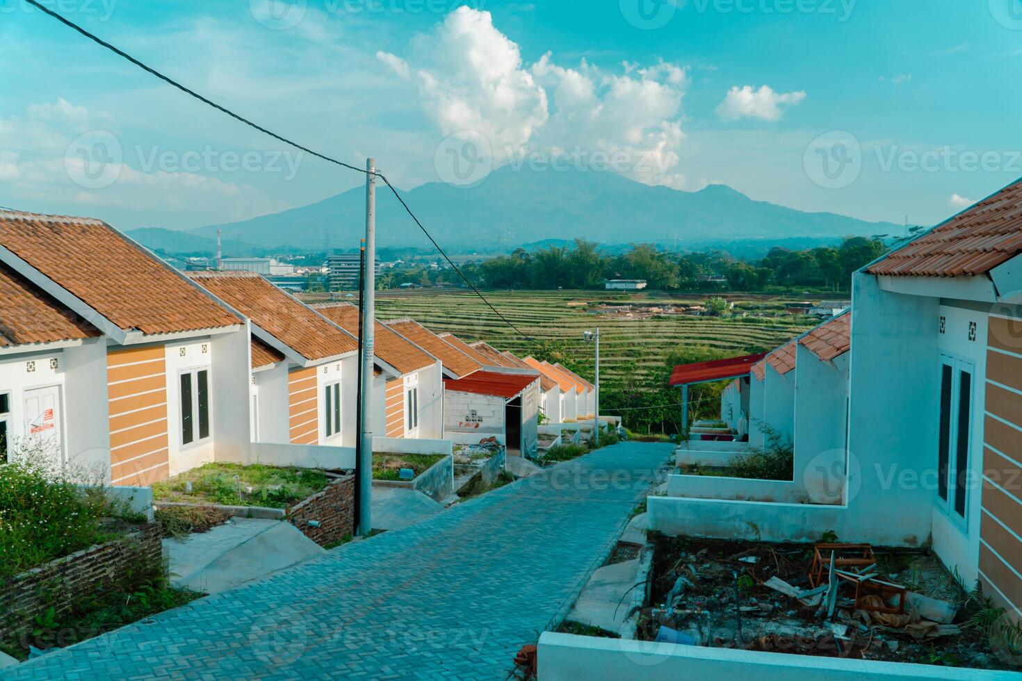 Residential area with beautiful views with a backdrop of green rice fields and mountains that look magnificent from a distance. Public housing complex on hills with sloping land with mountain views photo