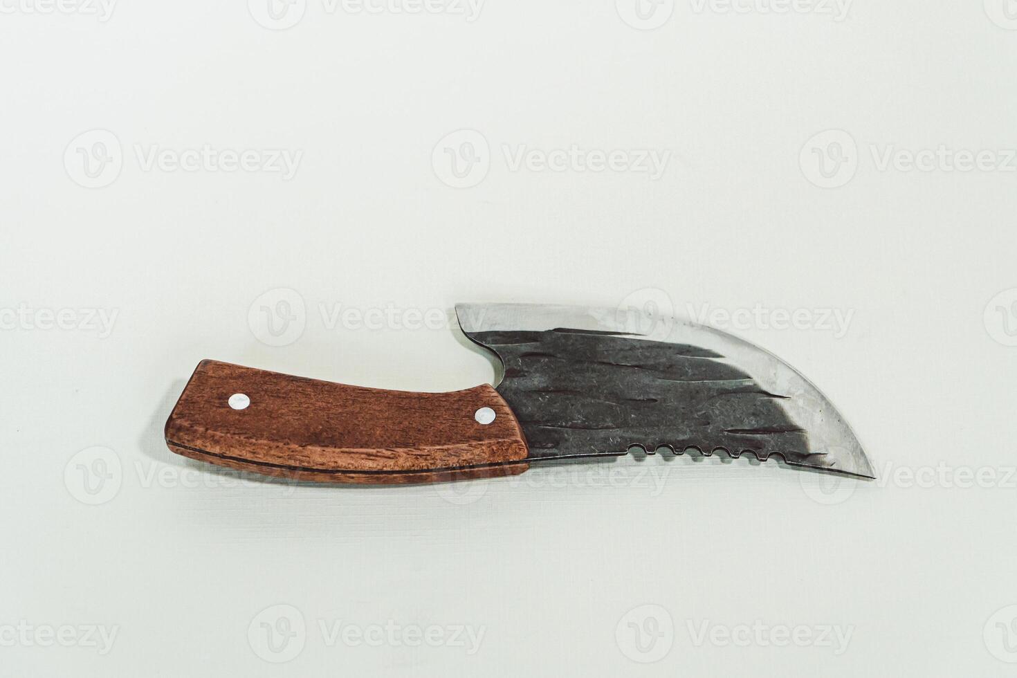 Close up of an adventure and bushcraft knife using a wooden handle. Knife with a sharp stainless steel blade with a wooden handle, perfect for outdoor adventures and bushcraft activities photo