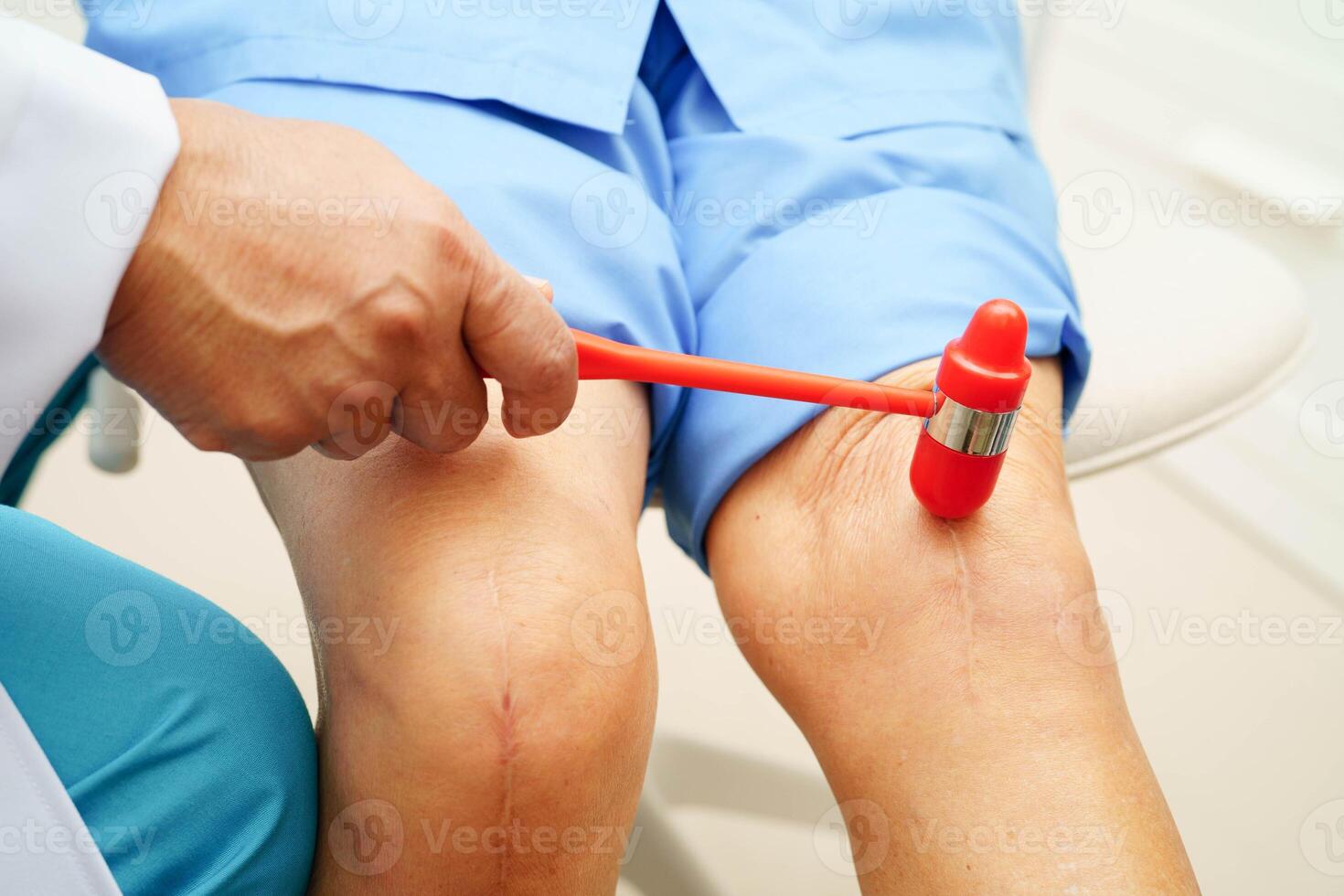 Asian doctor knock on knee reflex nerve for check and treatment senior patient in hospital. photo