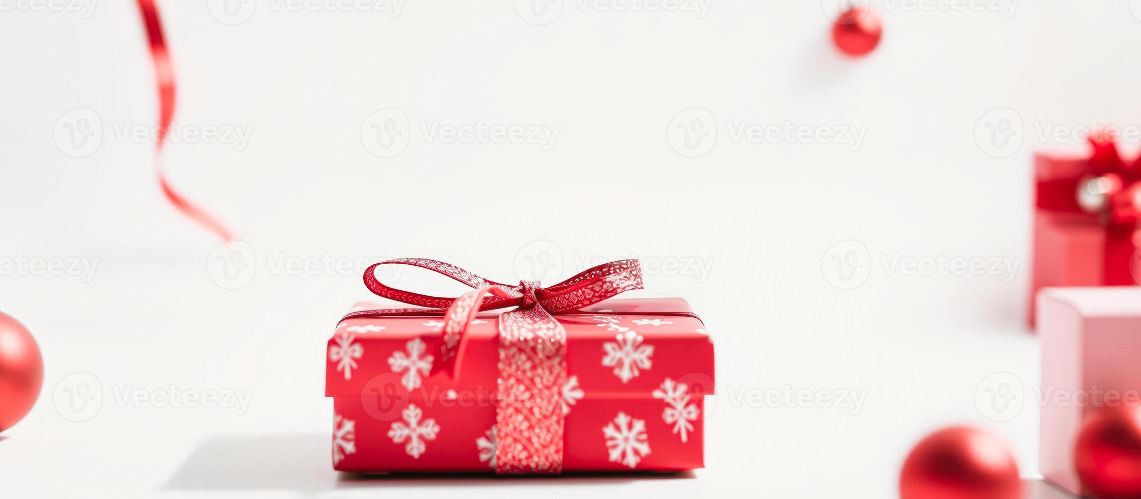 Red Gift Box with Bow and Snowflake Pattern on White Background photo