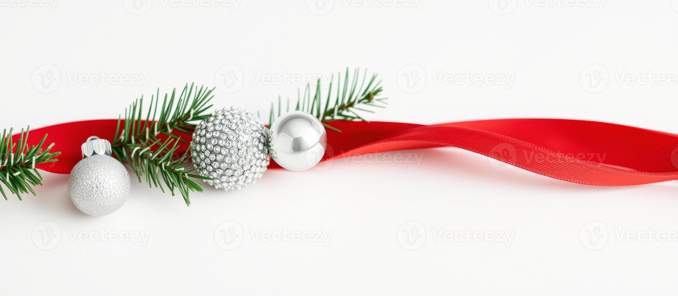 Red ribbon and silver Christmas ornaments with pine branches photo