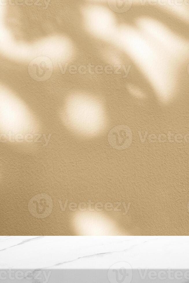 Minimal Marble Table with Light Beige Concrete Wall in Vertical Background with Leaves Shadow and Bokeh photo
