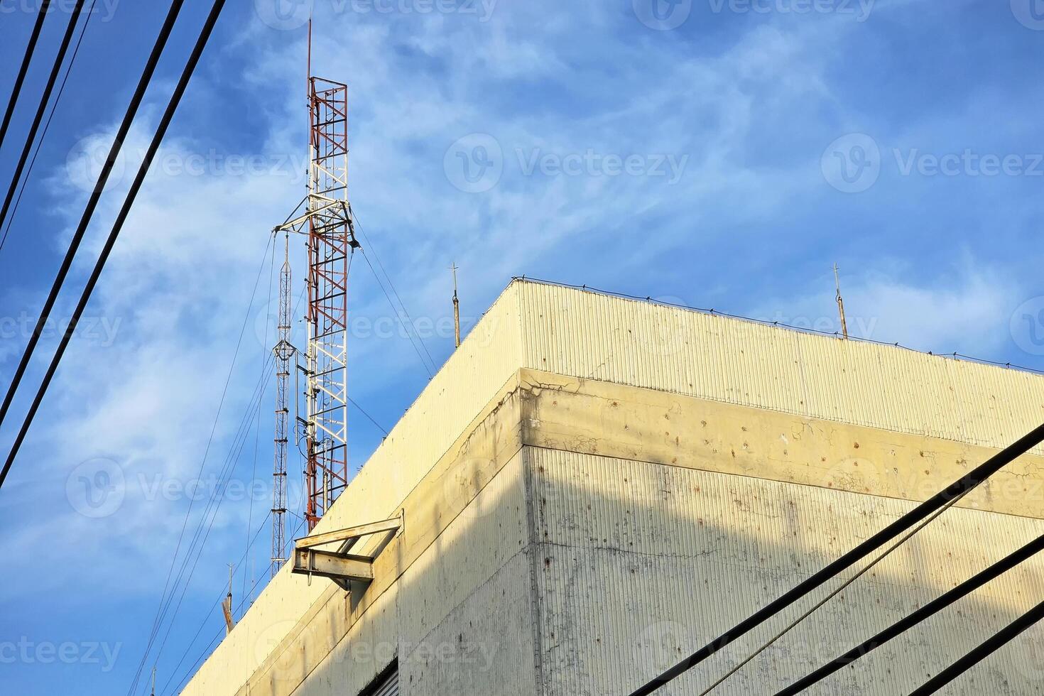 Telecom Pole on Roofs with Blue Sky. photo