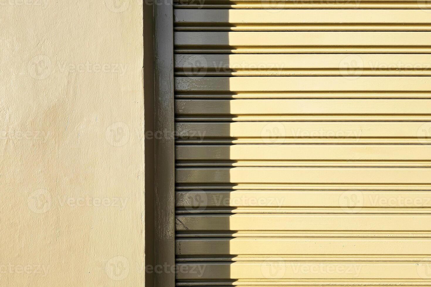 Green Concrete Pole and Foldable Door with Shadow and Light. photo