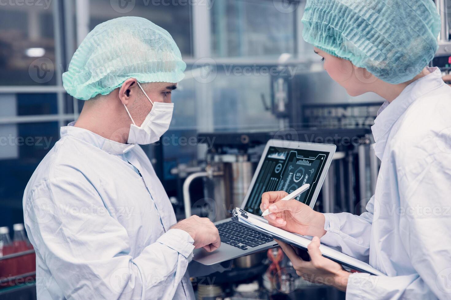Food and Drink factory worker working together with hygiene monitor control mix ingredients machine with laptop computer photo