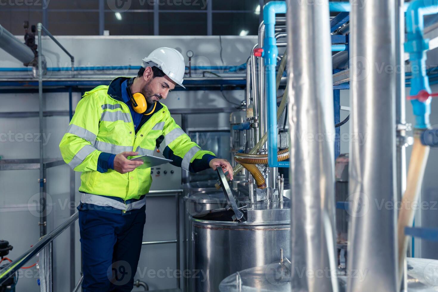 Industrial factory worker, Engineer staff working in food and drinks factory, Control check quality condition of liquid pipe supply in plant. photo