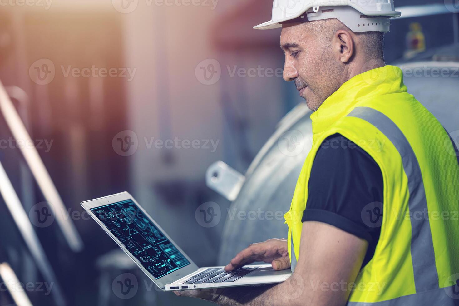 Smart Engineer using laptop computer software program application to help support work service machine on site factory. photo