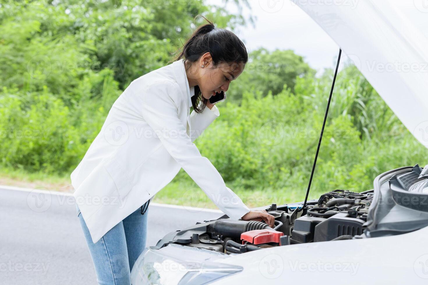 Young woman calling help and insurance auto service with a problem broken car on the road, angry upset worry expression. photo