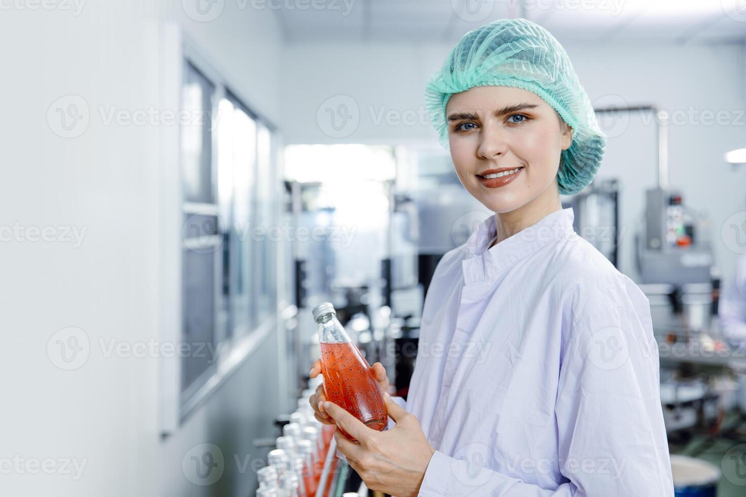 Portrait happy beverage factory worker. Drinks safety inspector in the food and drink factory production line with hygiene. photo