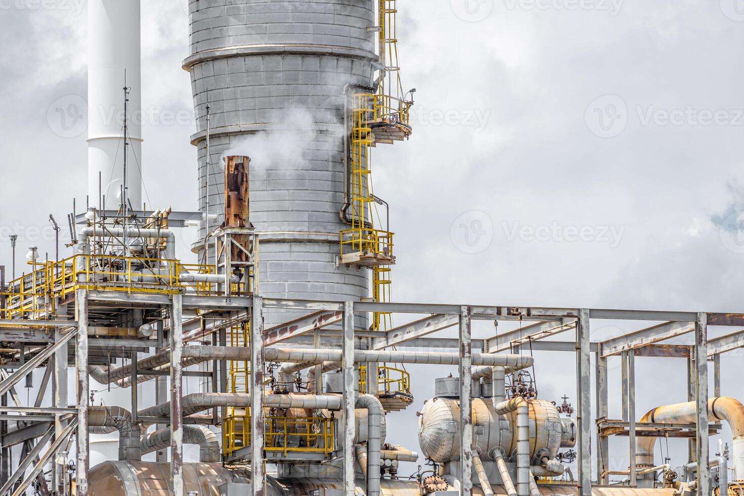 Oil petroleum refinery plant building distillation columns tower, Closeup part of fuel gas pipe complex, Crude oil petrochemical industrial building. photo