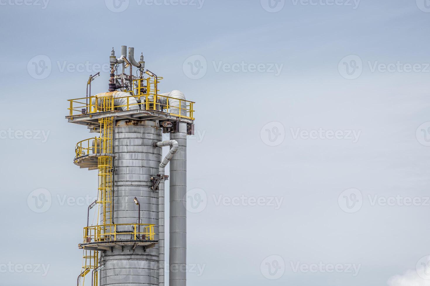 Oil petroleum refinery plant building distillation columns tower, Closeup part of fuel gas pipe complex, Crude oil petrochemical industrial building. photo