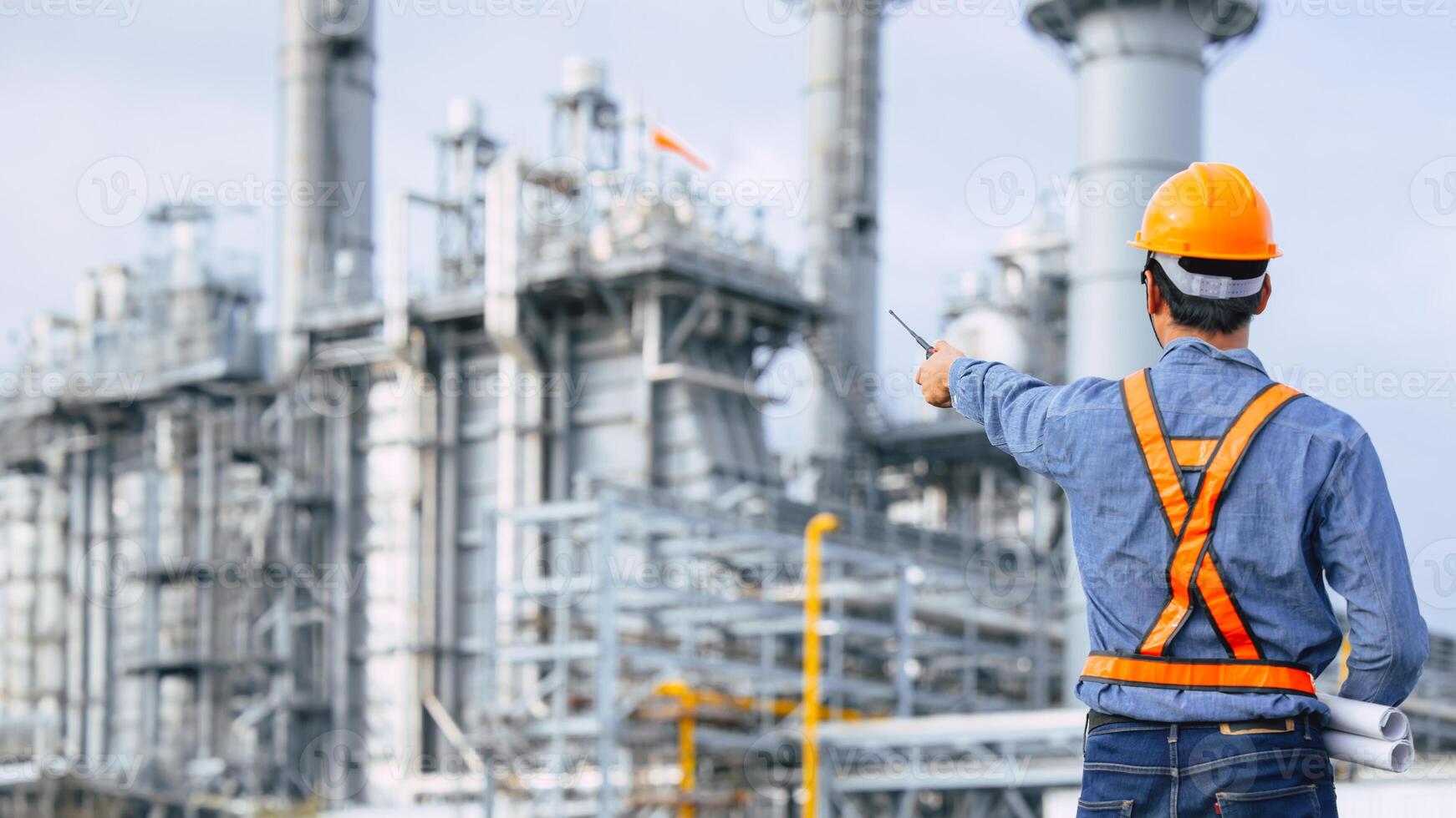 Petroleum Refinery industry engineer male working against oil and gas power industrial factory. Petrochemical power plant industry professional worker. photo