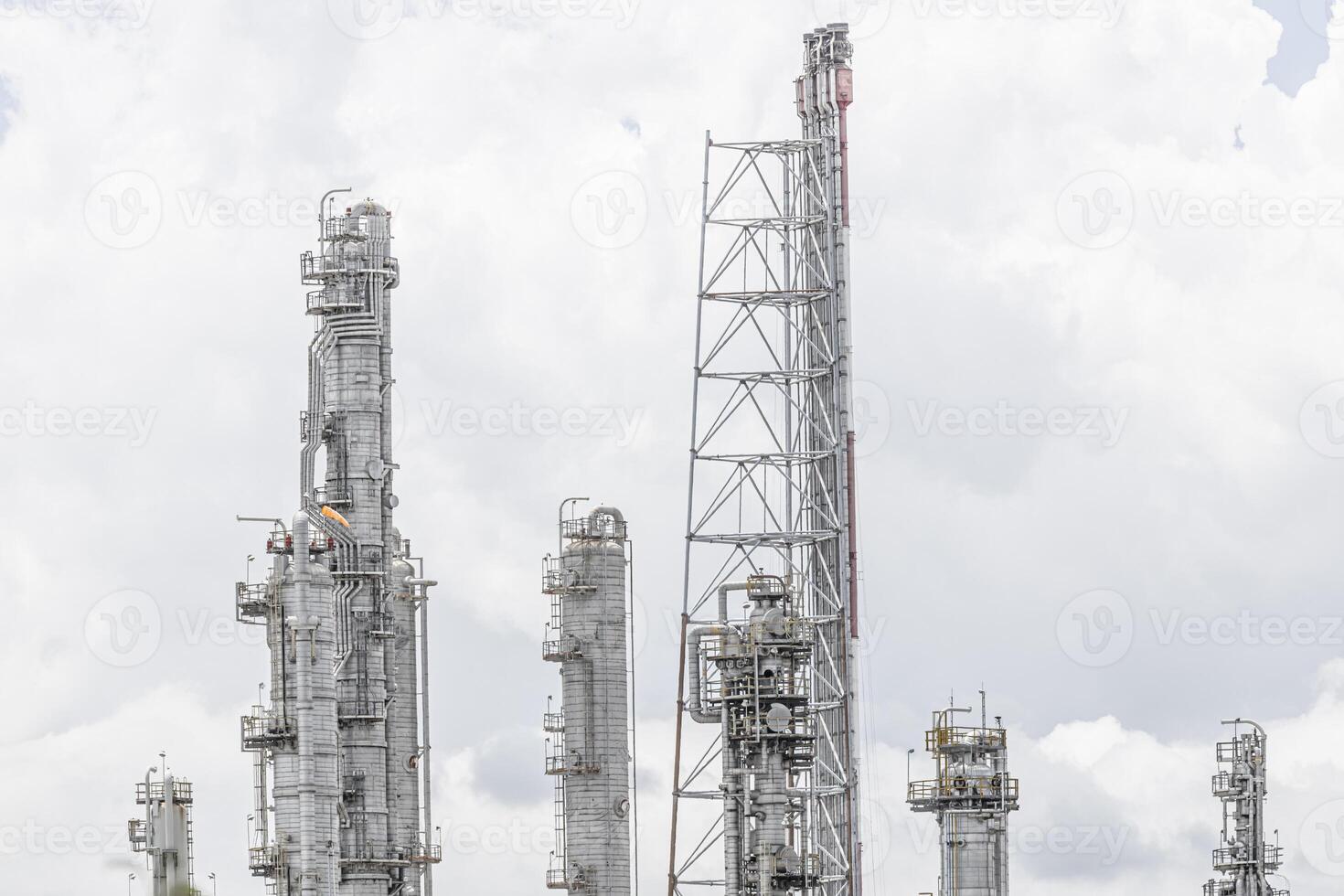Oil petroleum refinery plant building distillation columns tower, Closeup part of fuel gas pipe complex, Crude oil petrochemical industrial building. photo