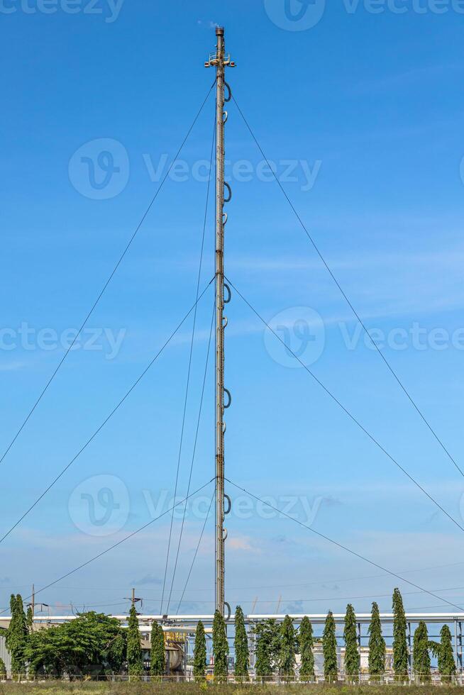 Methane Gas Fire High Flare Stack Flaring Tower Platform in Refinery Petroleum Plant or Flame Burn On Offshore Oil Extraction Process. photo
