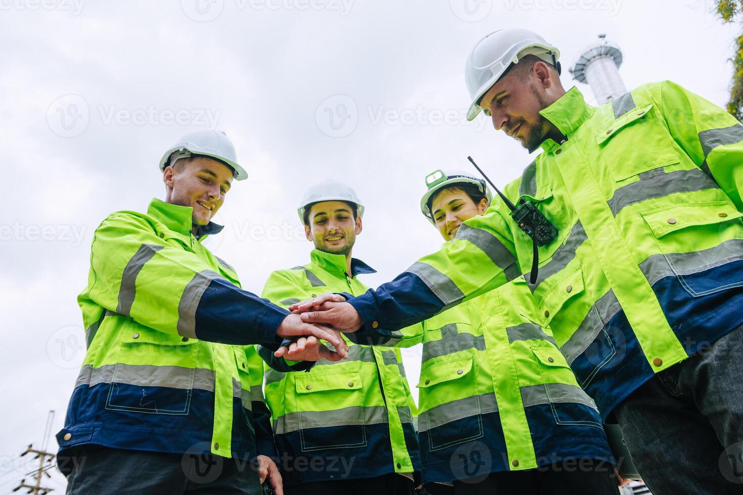 Group of Refinery Engineer team workers Join Hand for Collaboration Working. Industrial Worker Mix Together. Workers hands meeting job successfully. photo