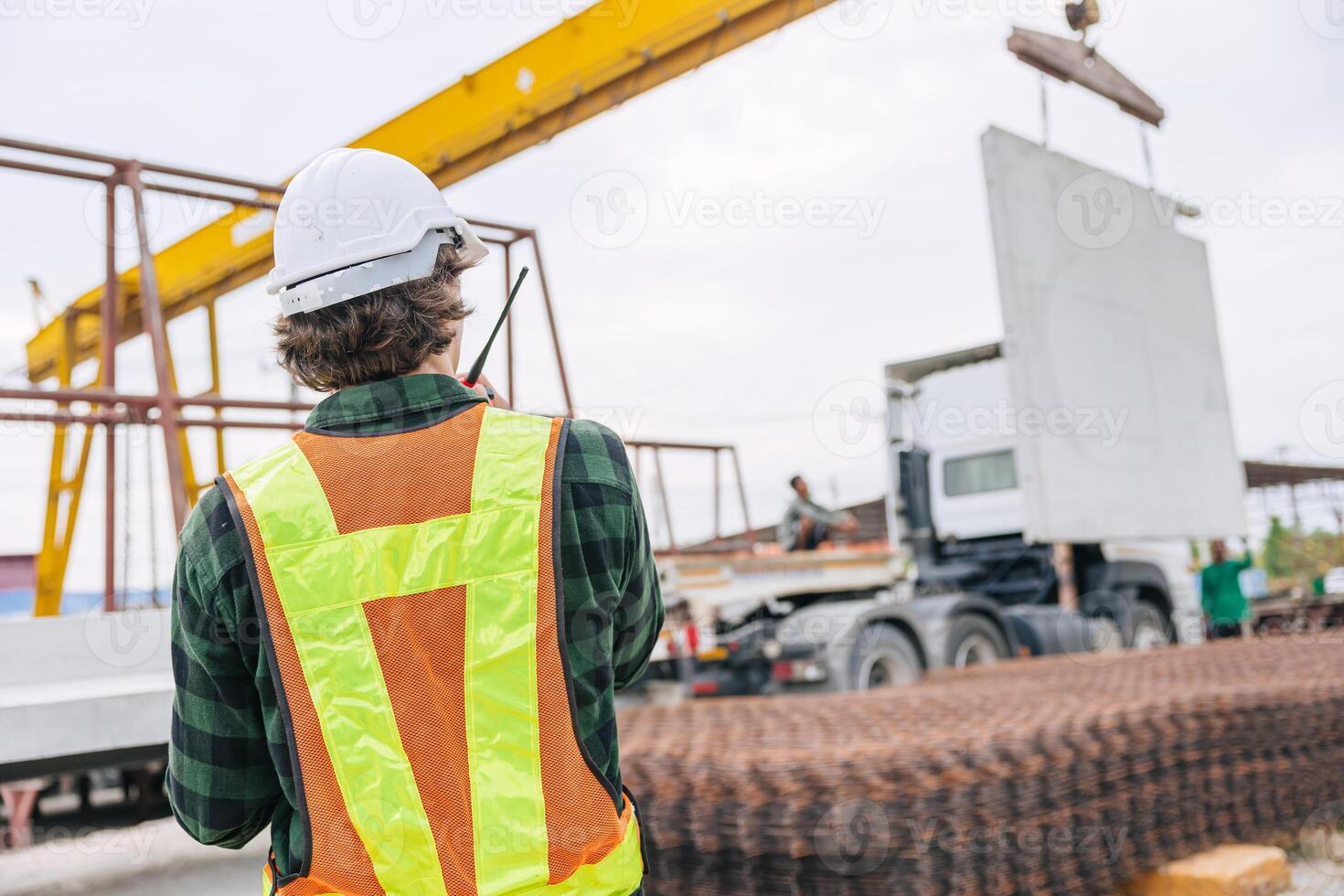 Professional engineer male working in concrete precast plant factory control operate lifting crane in construction site . photo