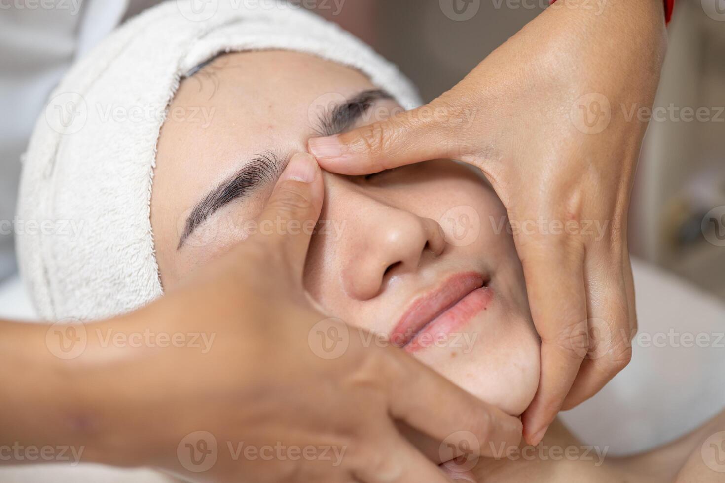 Beauty women facial hand finger press message in spa, Face skin treatment body care relax claim with skincare baby face at wellness. photo