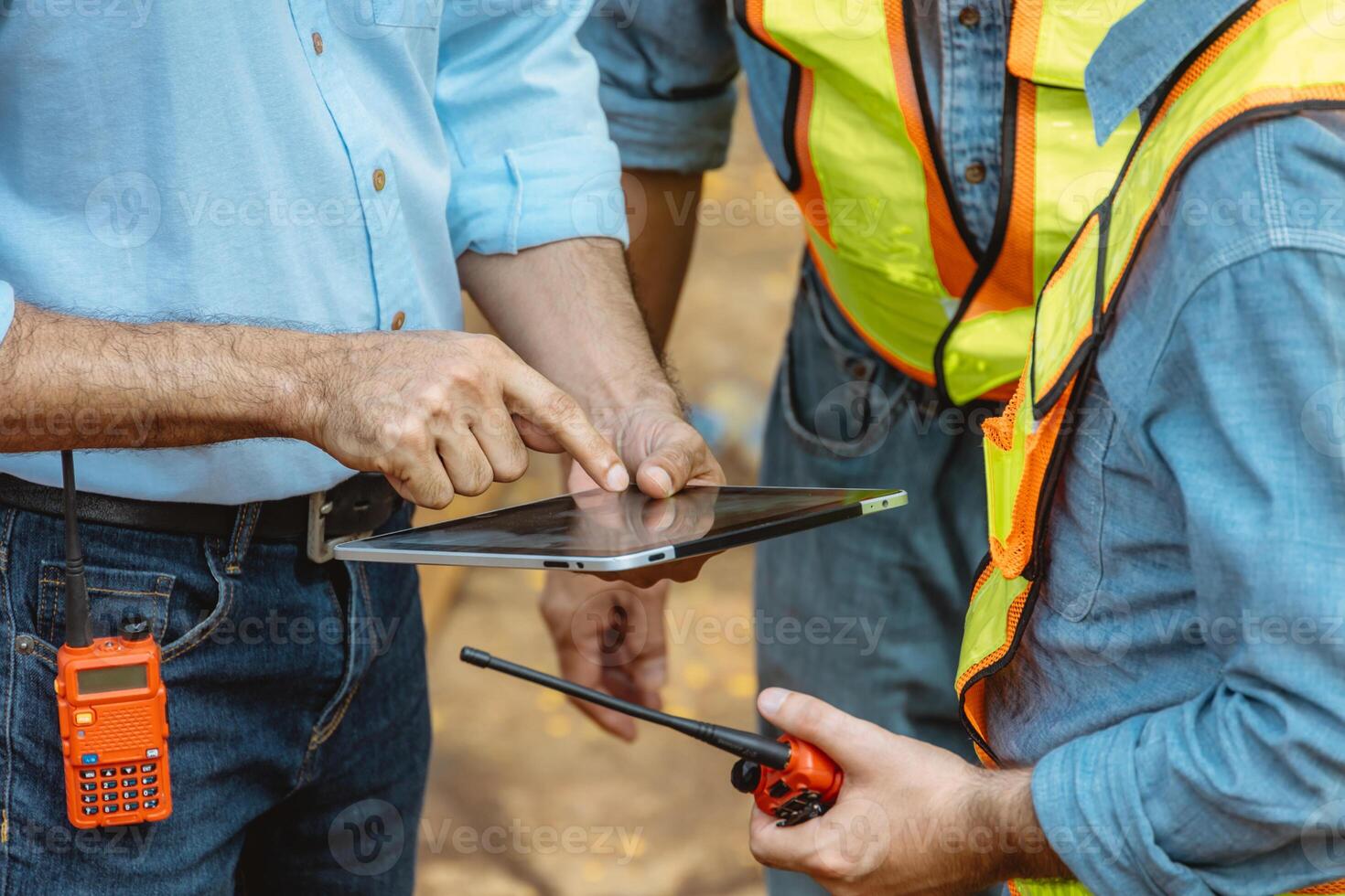Professional construction engineer workers team working cooperate together consulting looking at tablet screen at project building construction site. photo