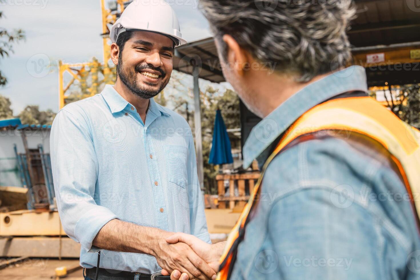 Workers team hand shaking deal with contractor happy at construction site. Engineer project business contact connection people concept. photo