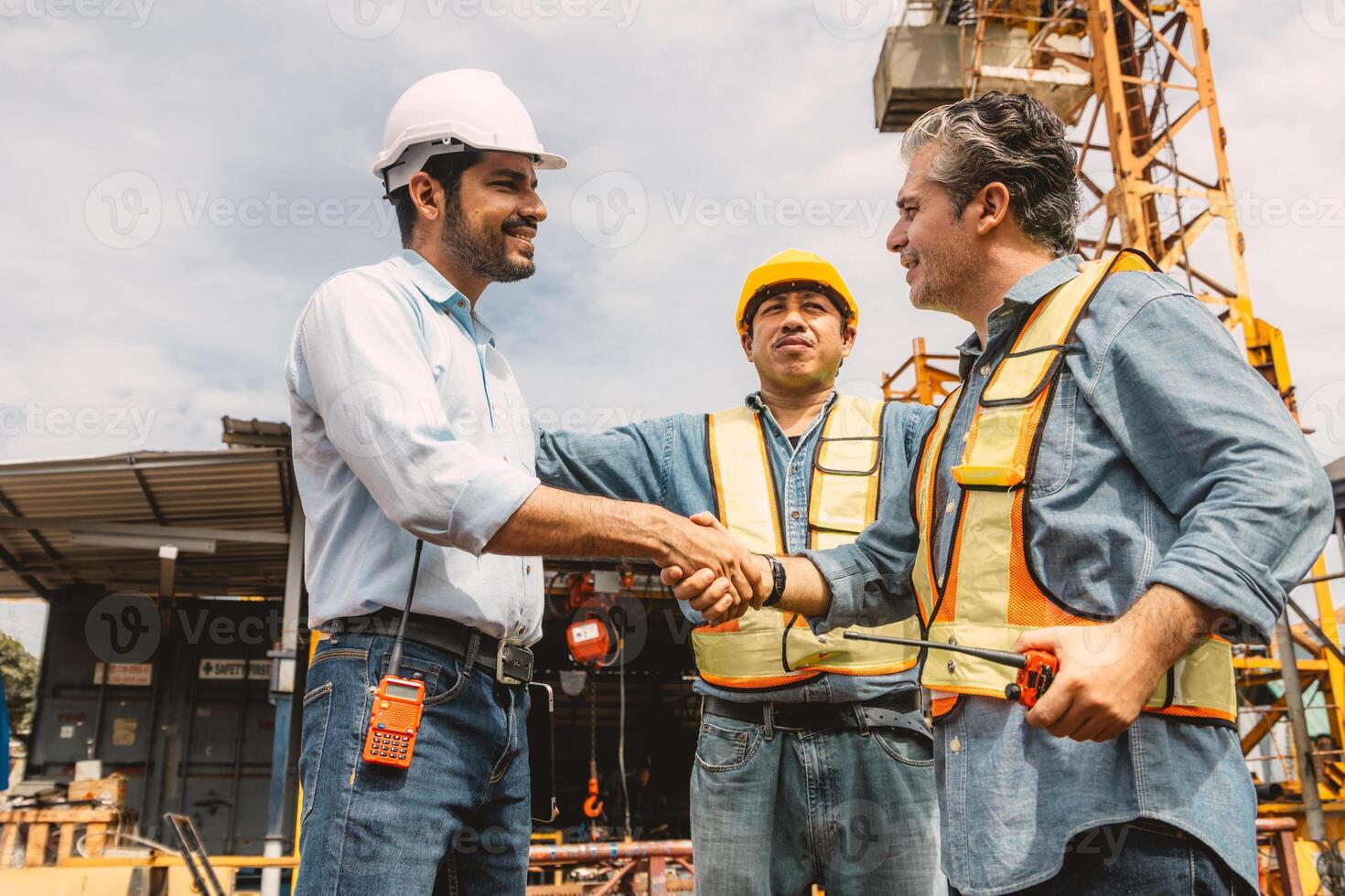 Workers team hand shaking deal with contractor happy at construction site. Engineer project business contact connection people concept. photo
