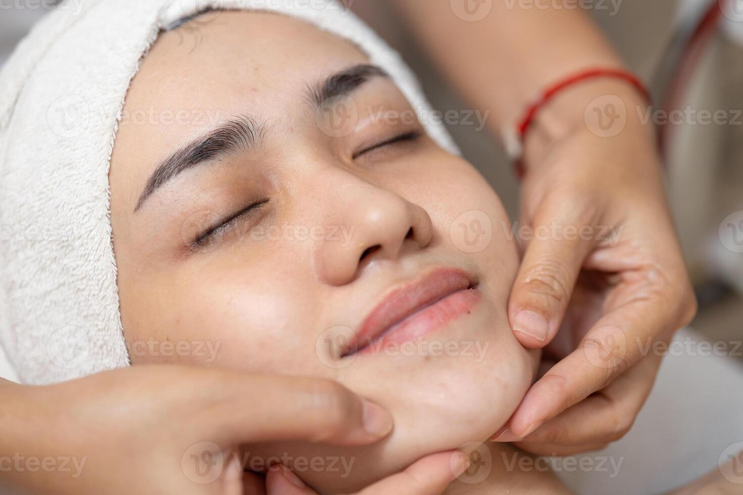 Beauty women facial hand finger press message in spa, Face skin treatment body care relax claim with skincare baby face at wellness. photo