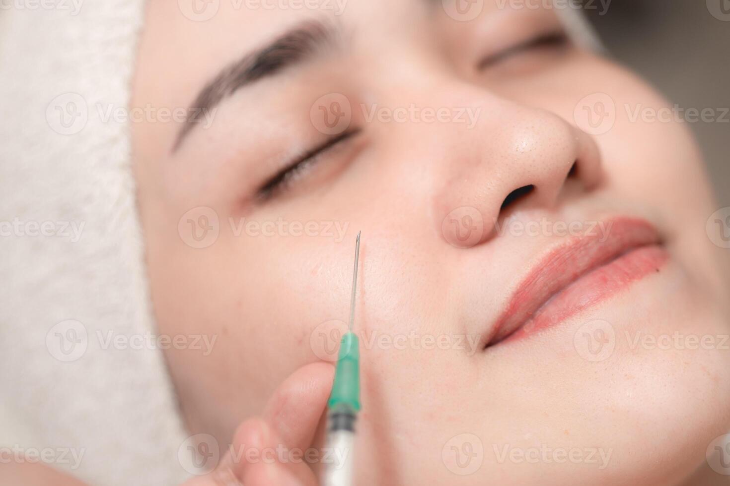 Woman needle injection facelift. Medical Filler for face lifting remove wrinkles in facial spa skin care clinic process. photo