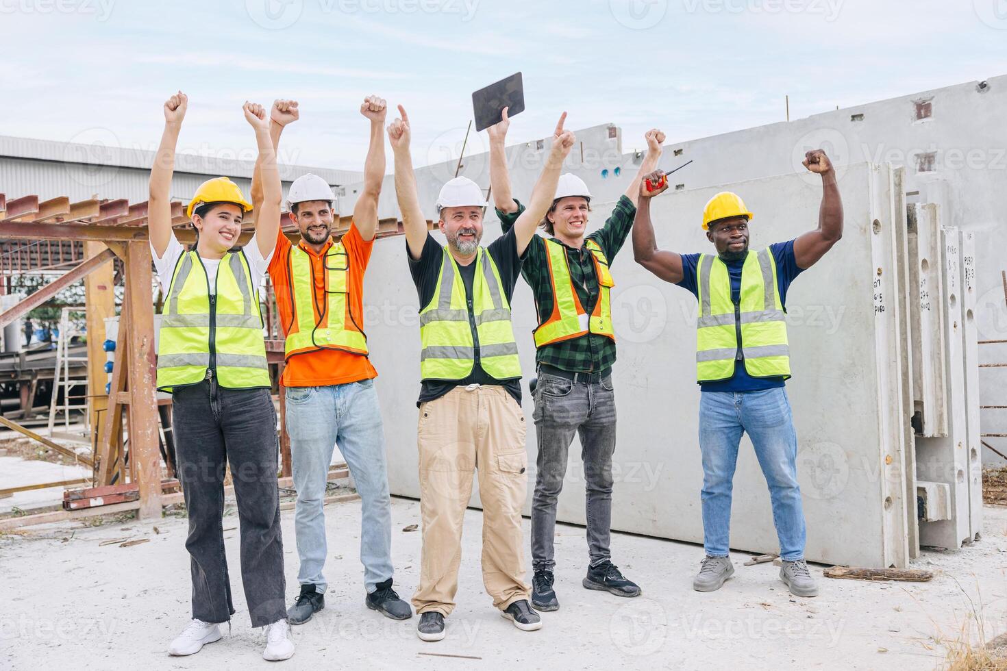 Group of workers teamwork in construction industrial plant. Diverse workers standing together. Happy cheerful Industrial engineer people team concept. photo
