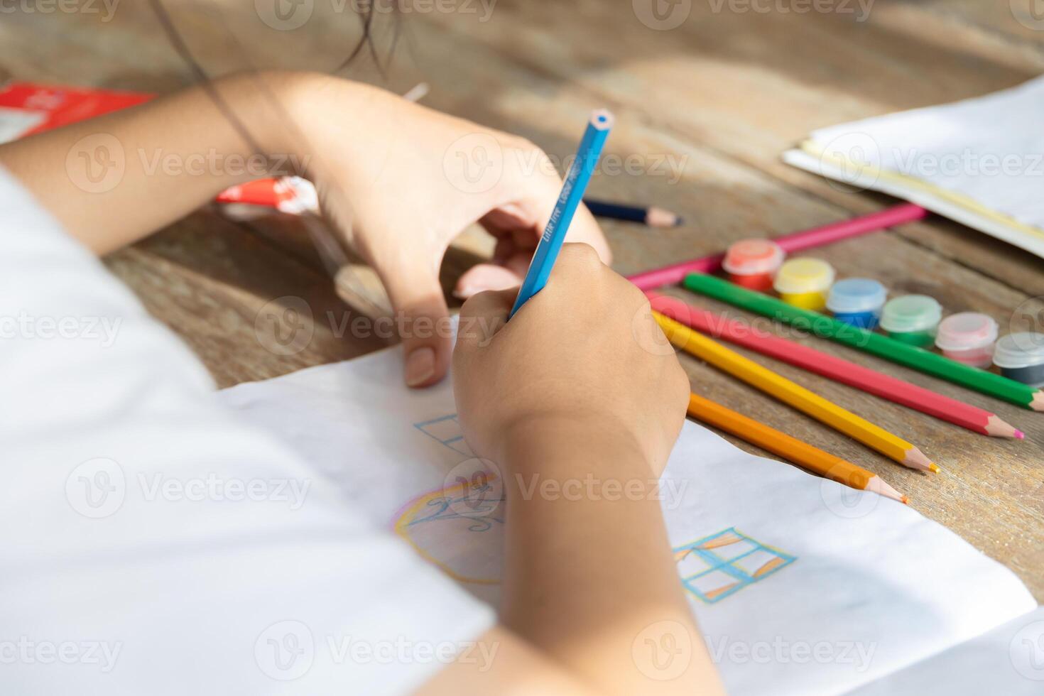 closeup student hand using colors pencil drawing art painting with imagine and creativity class photo