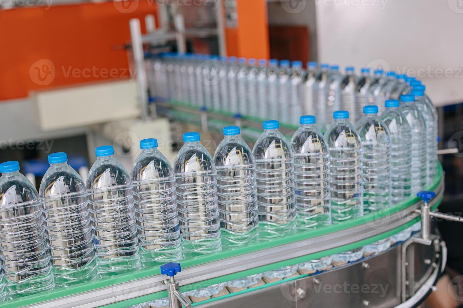 Drinking water production line on conveyor belt. Plastic water bottles in drink factory. Pet bottles industry. photo