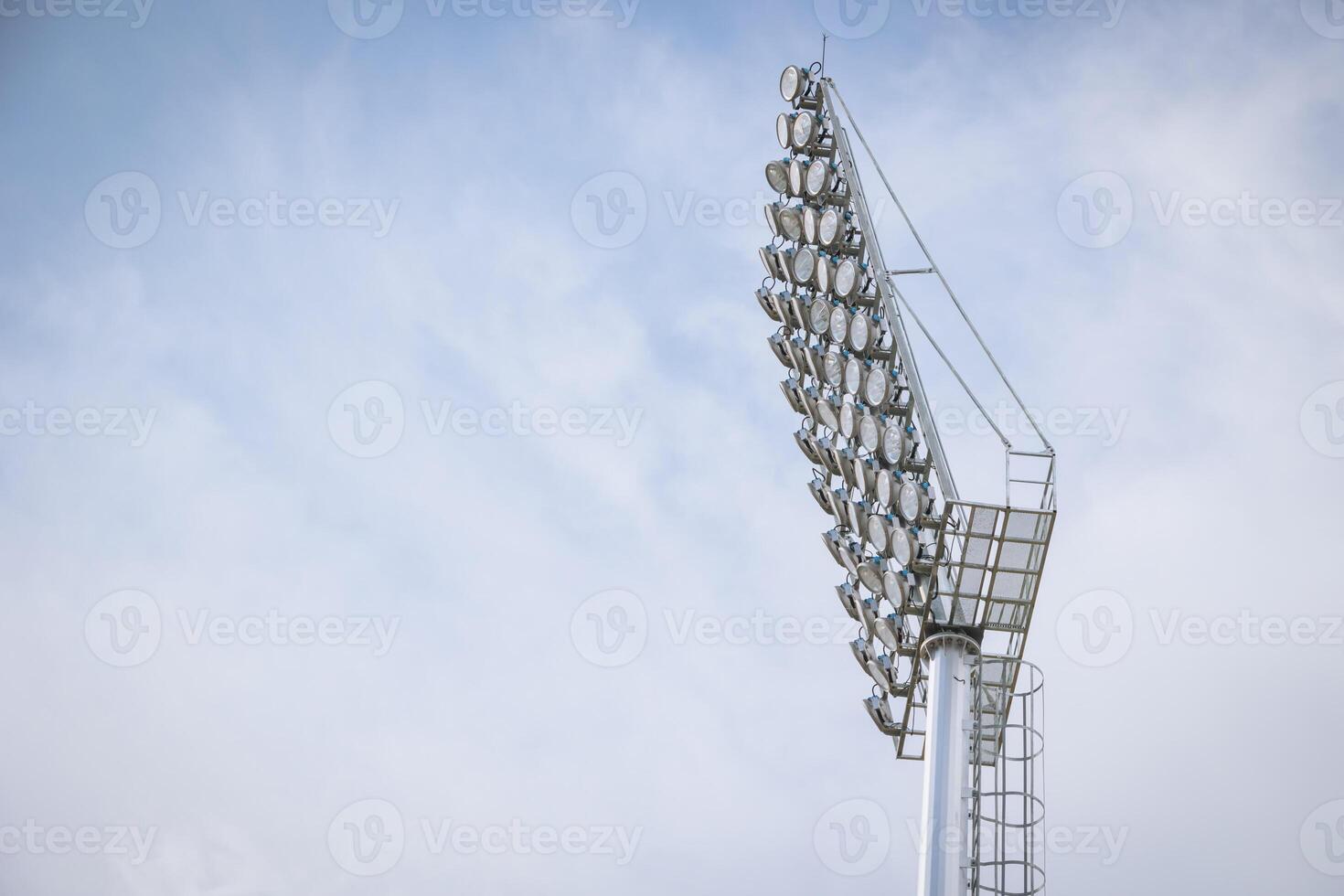 Stadium large high power lighting, Floodlights over a sports field outdoors against blue sky. photo