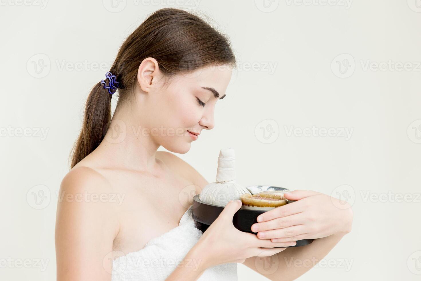 Beauty women caucasian model with herbal spa massage cream set isolated on white background photo