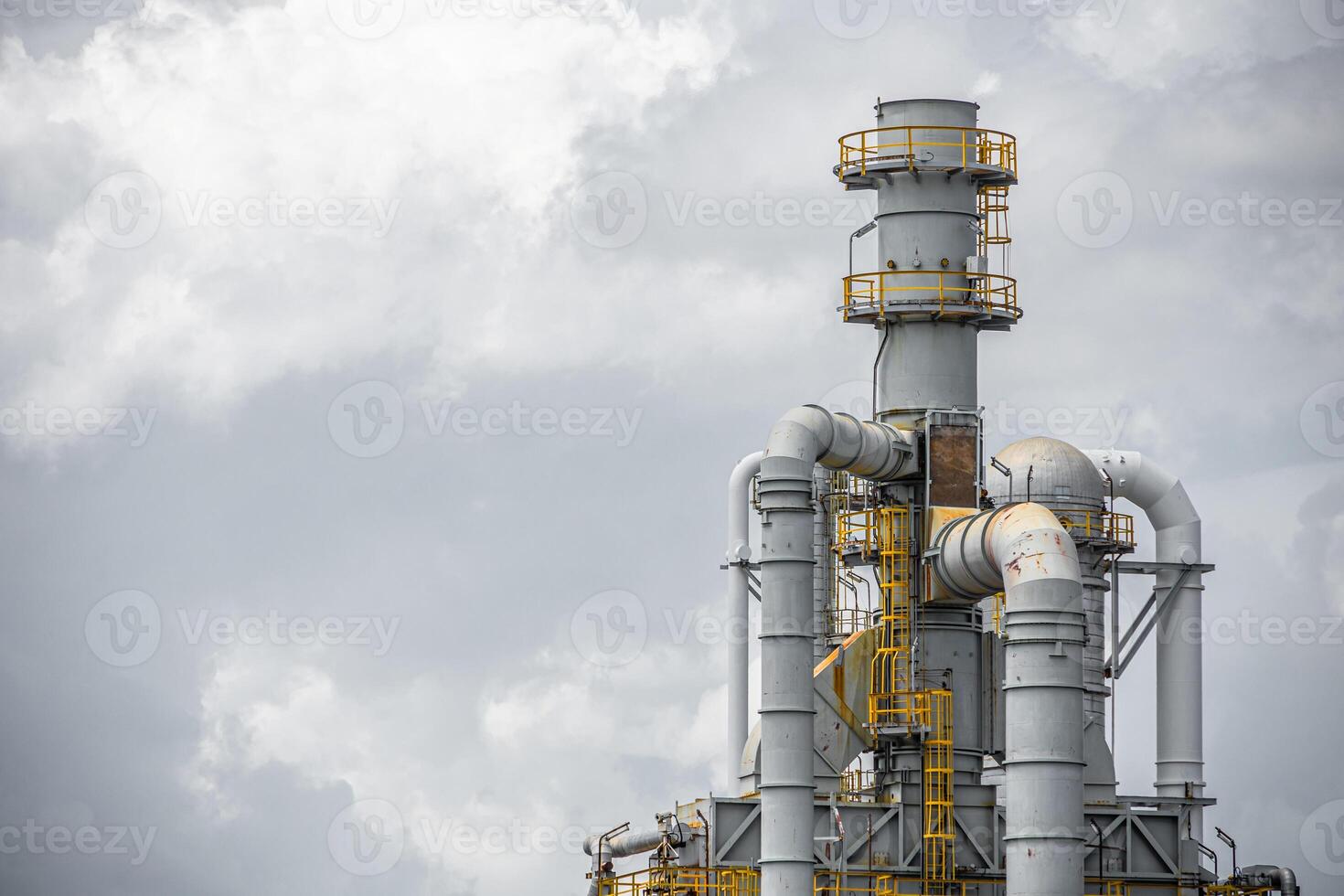 Oil petroleum refinery plant building distillation columns tower, Closeup part of fuel gas pipe complex, Crude oil petrochemical industrial building. photo
