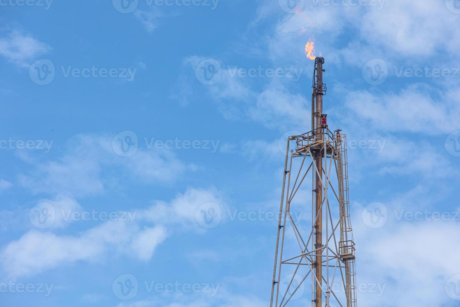 Methane Gas Fire High Flare Stack Flaring Tower Platform in Refinery Petroleum Plant or Flame Burn On Offshore Oil Extraction Process. photo