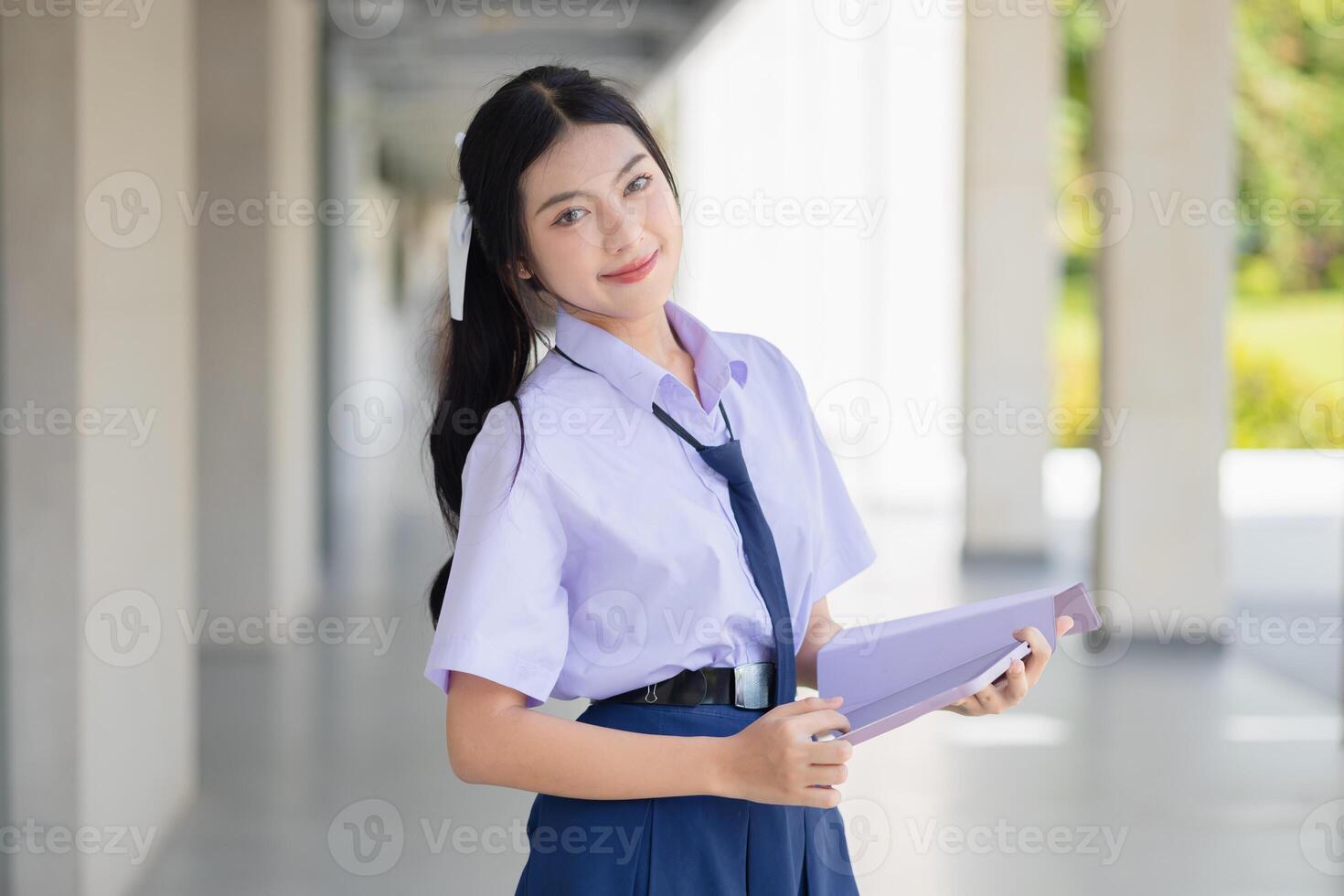 portrait school uniform teen girl standing happy smile indoor school campus for learning education back to school concept. photo