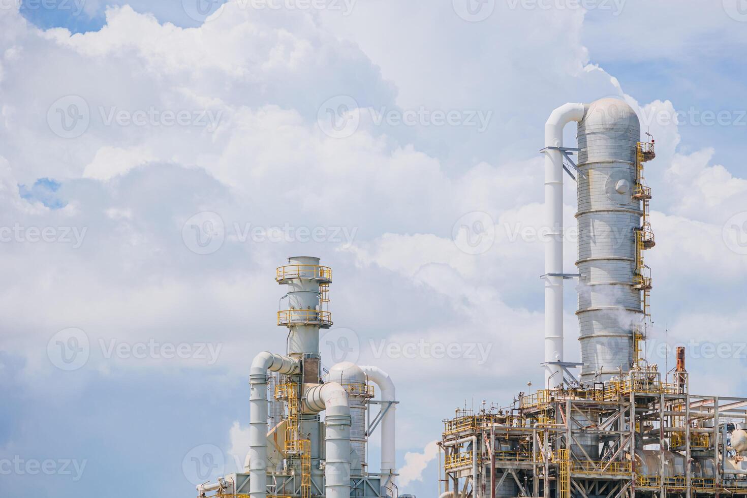 Petrochemical Petroleum Refinery Oil and Gas plant industrial complex building with Atmospheric distillation tower landscape summer blue sky. photo