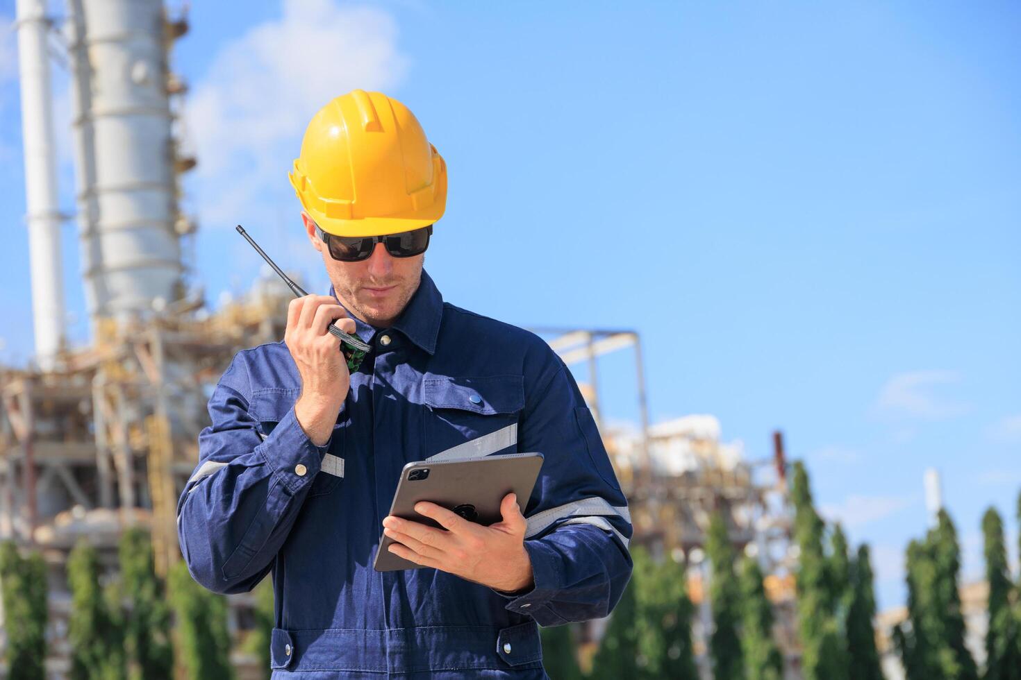 Industrial Worker Inspection Processing Plant Walkie Talkie Looking Tablet, Engineering Industry Safety Outdoors Working Professional Communication Hardhat Control Site Construction Refinery Plant. photo