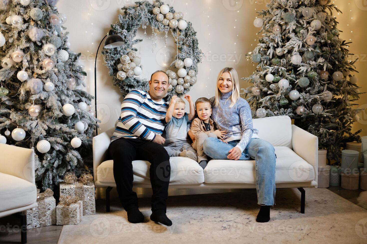 Family enjoys christmas morning, opening presents and laughing together photo