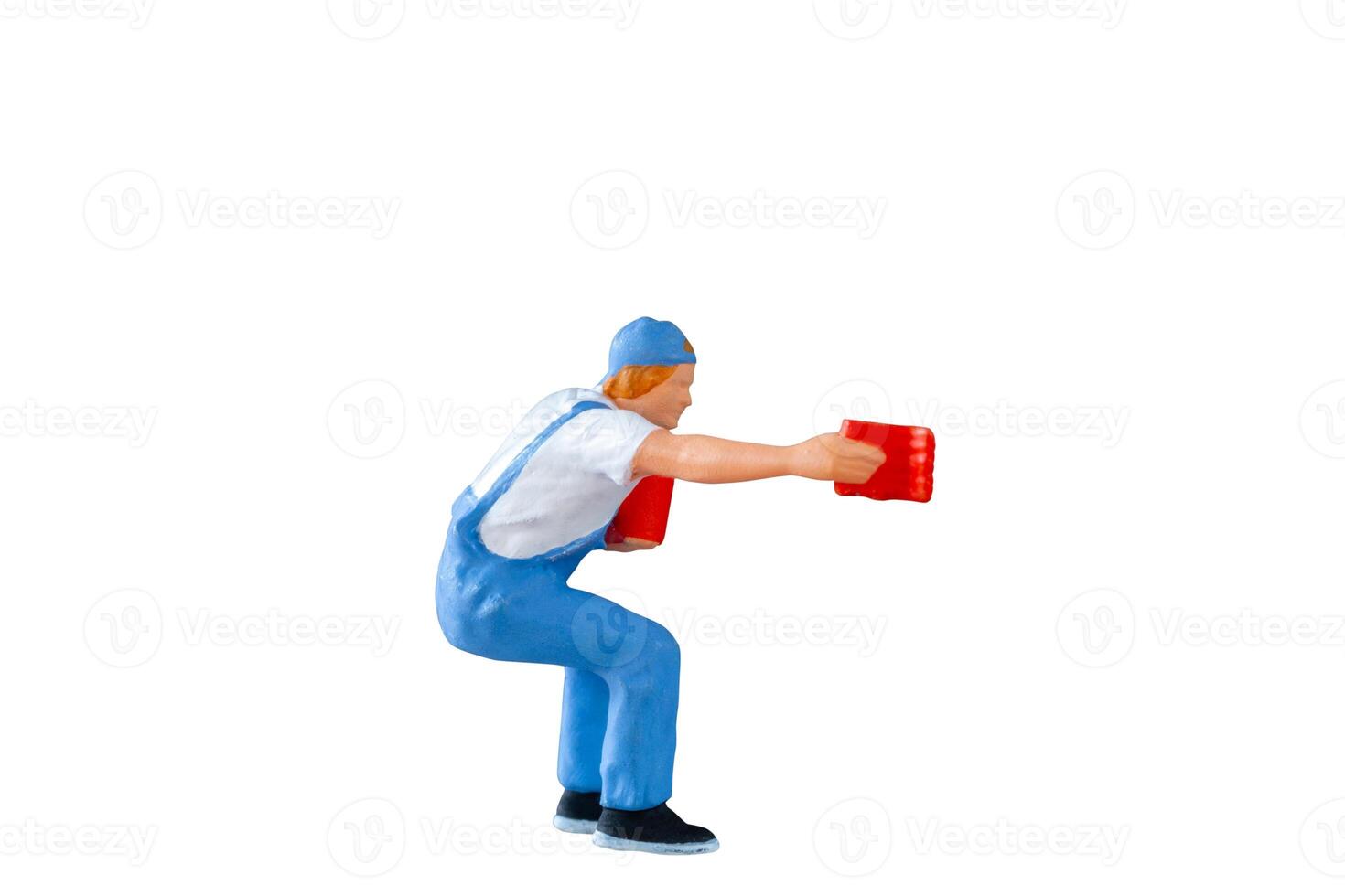 A miniature figurine of a painter holding a paint can and brush isolate on white background with clipping path photo