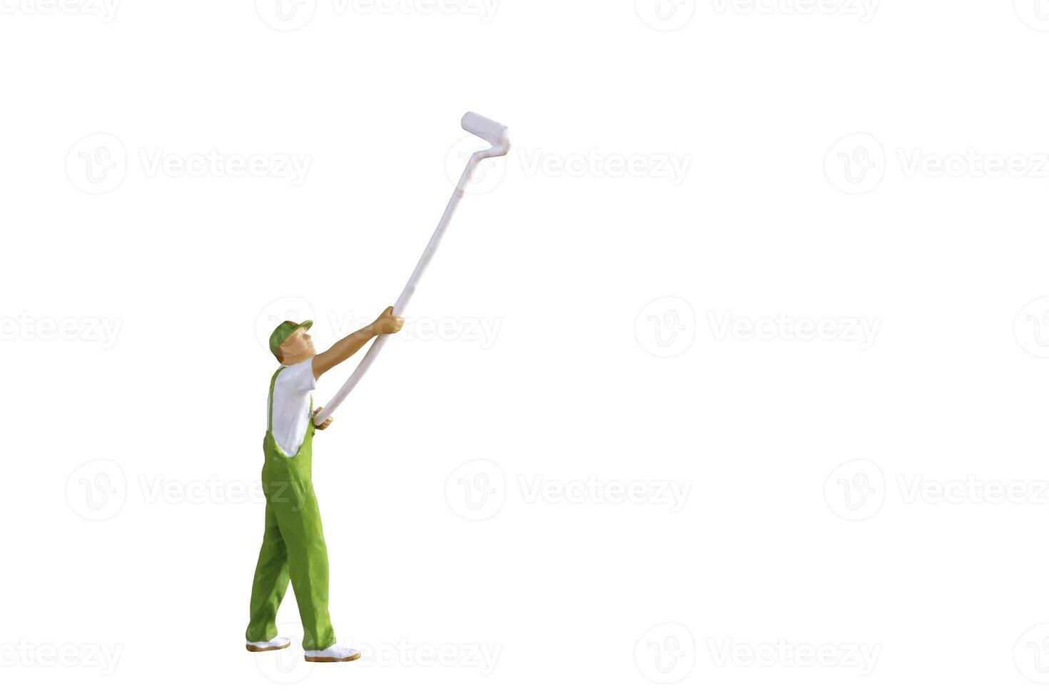 A miniature figurine of a painter holding a long-handled roller brush, isolated on white background with clipping path photo