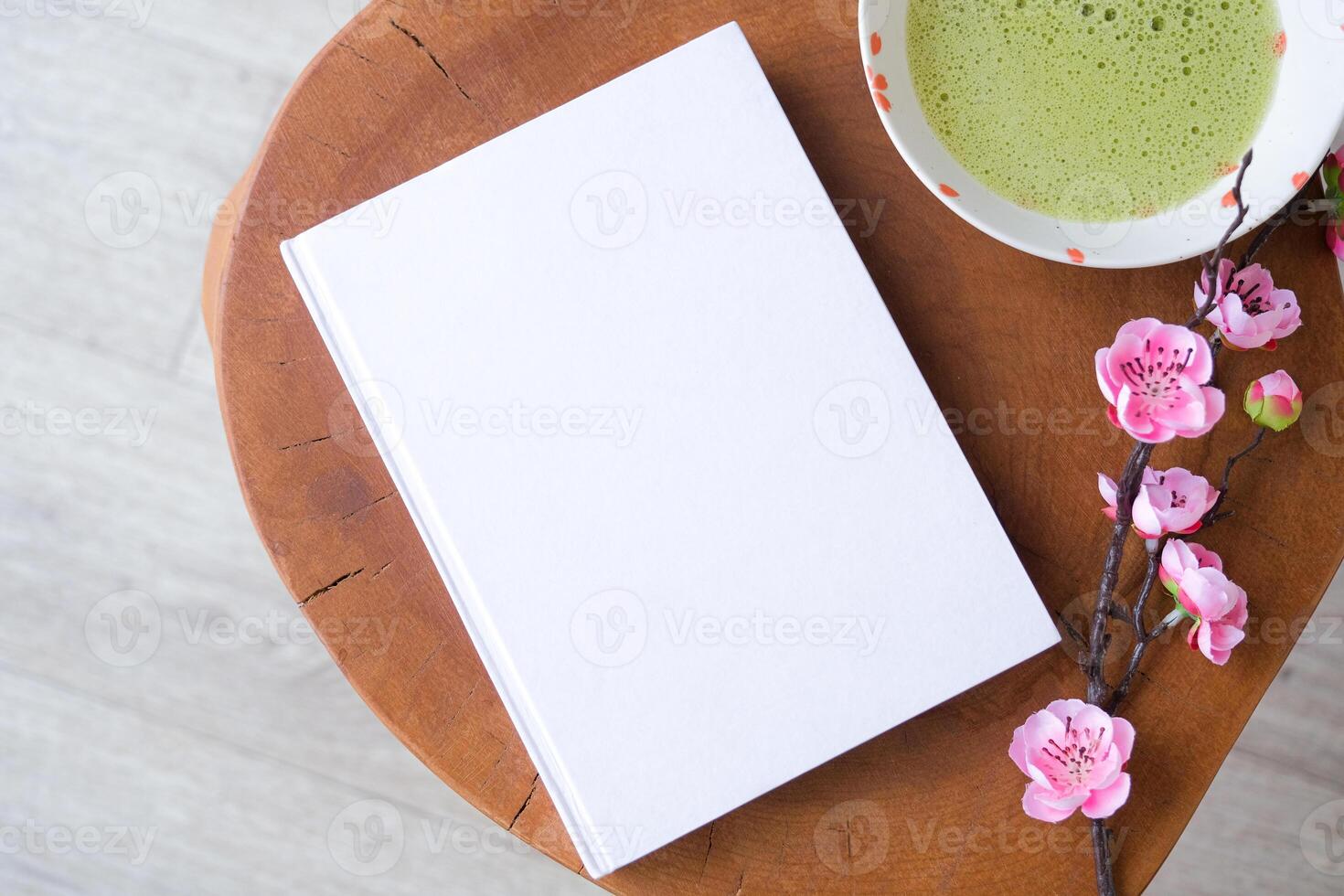 blank book mockup on coffee table with green matcha tea photo