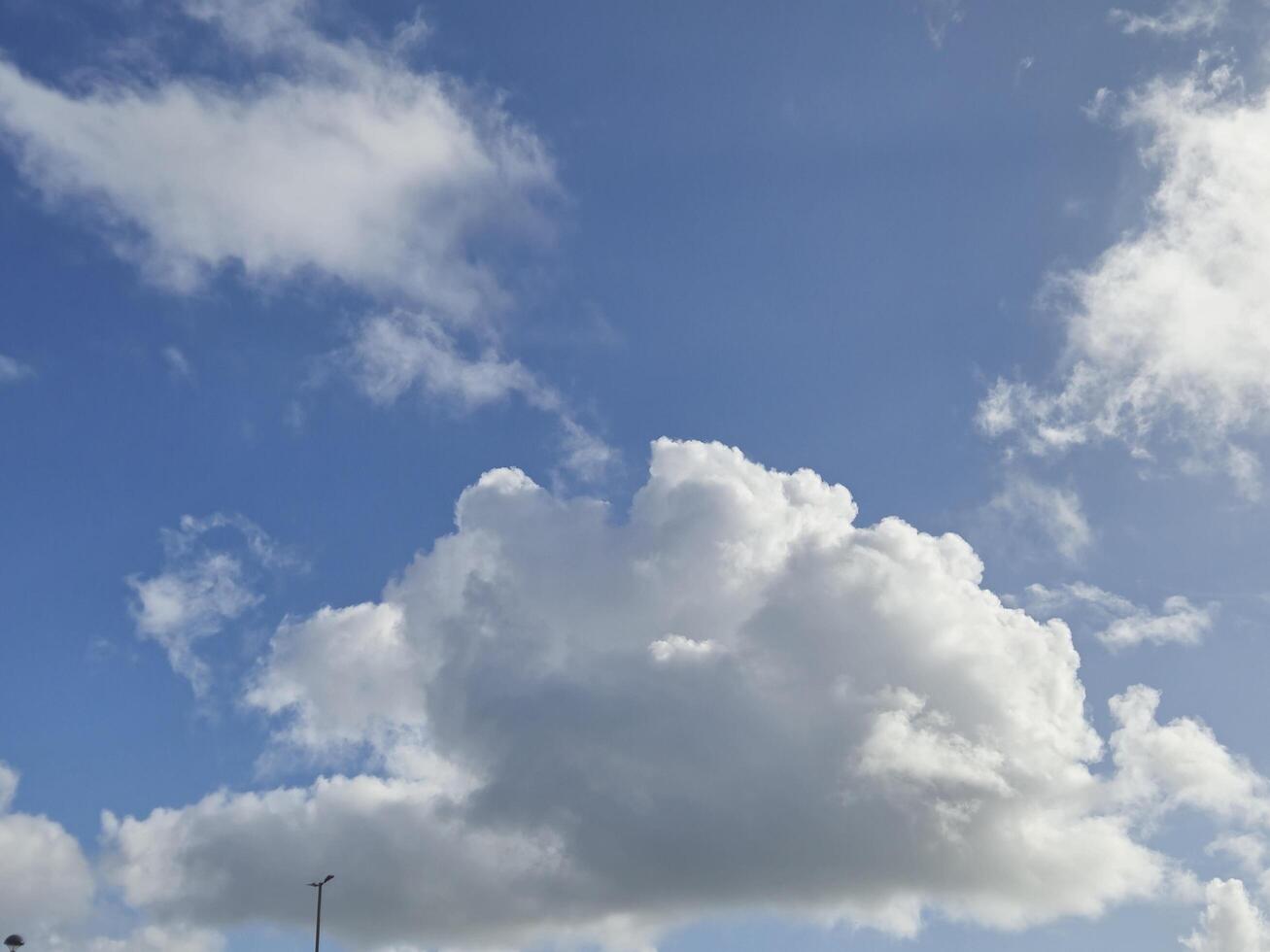 Clear Daytime Sky with Cumulus Clouds and Street Light photo