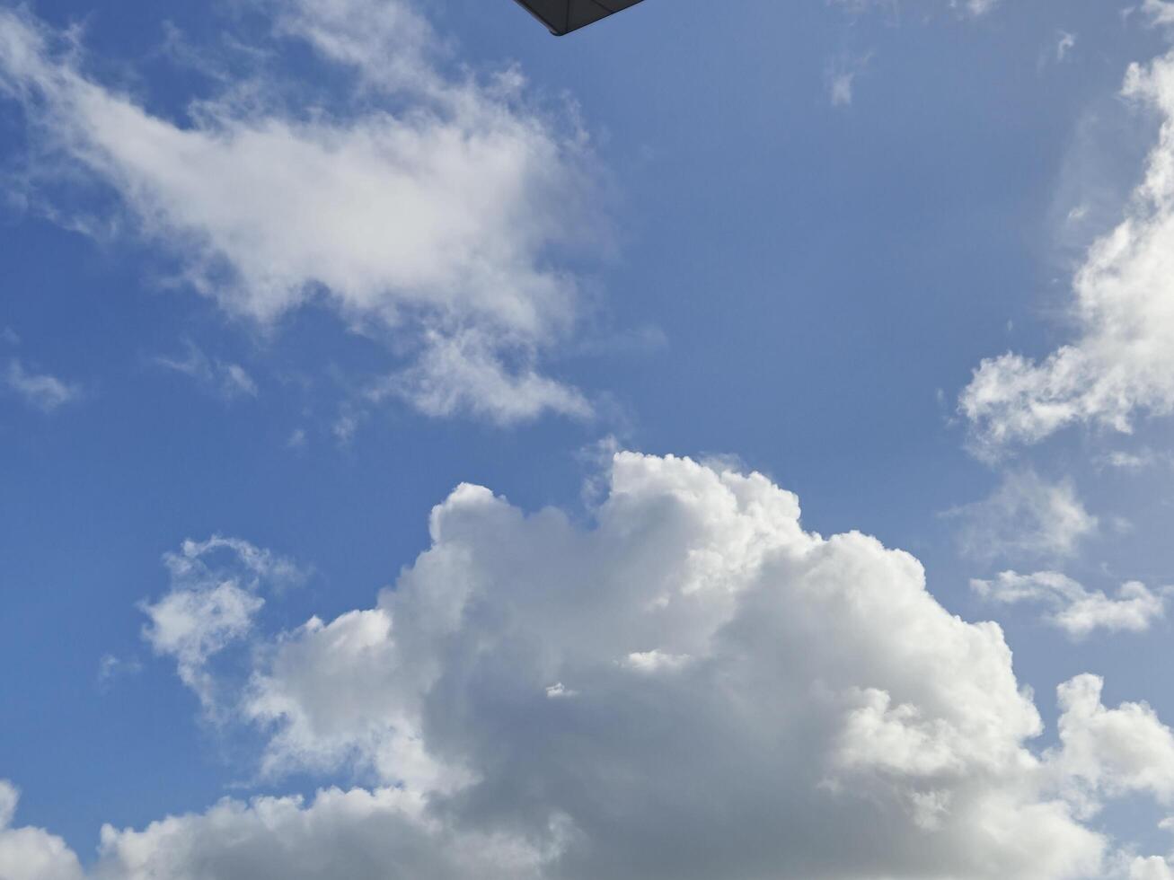Cumulus Clouds in a Bright Blue Sky with Sunlight photo