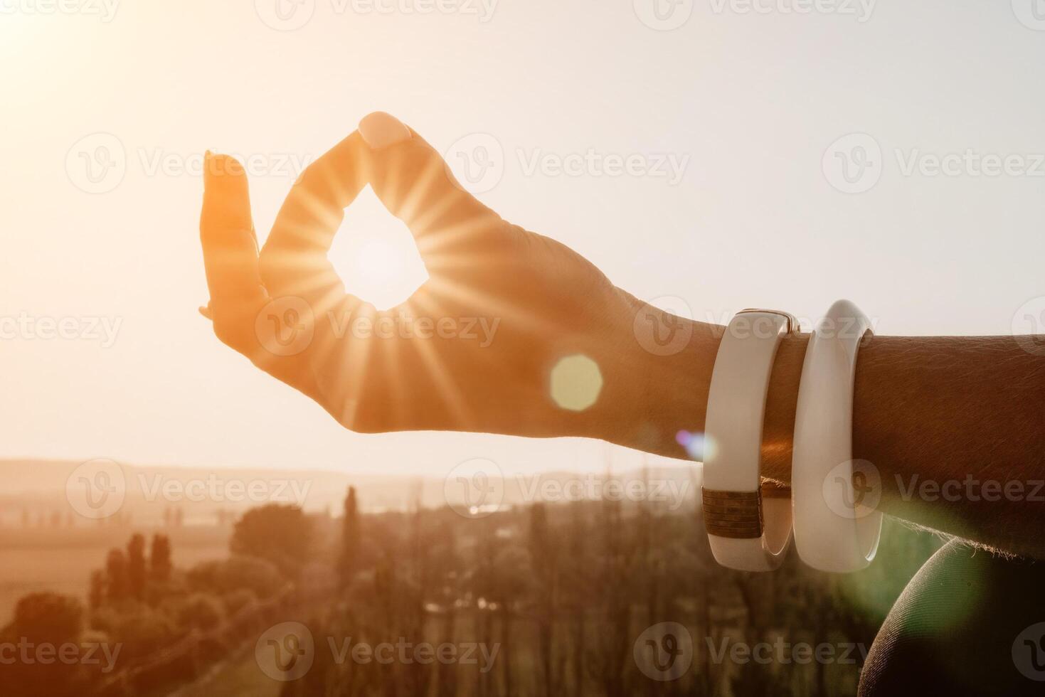 Fitness woman. Happy middle-aged fitness woman doing stretching and pilates on a rock near forest at sunset. Female fitness yoga routine. Healthy lifestyle with focus on well-being and relaxation. photo