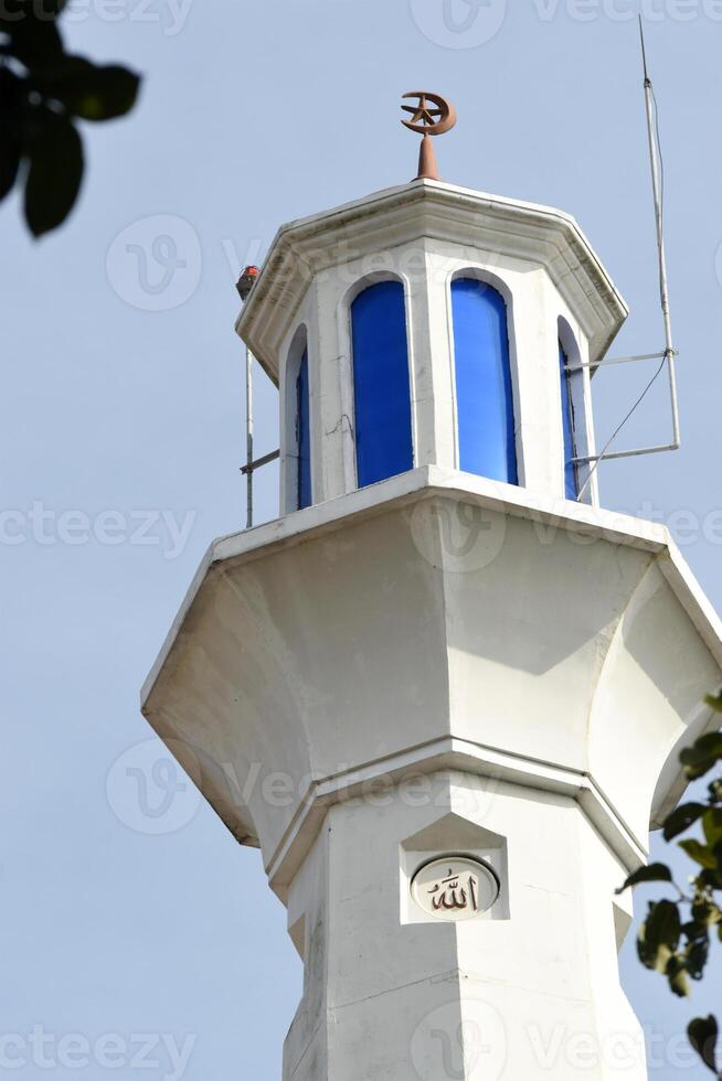 The top part of a mosque minaret photo